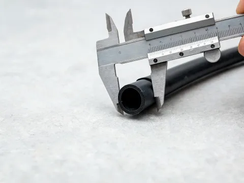Calipers measuring the cut end of drip tubing